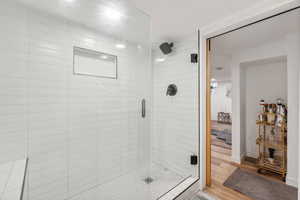 Full Bathroom featuring wood-type flooring and an enclosed shower