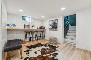 Bar featuring hardwood / wood-style flooring