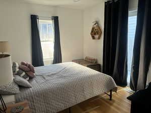 Bedroom with light wood-type flooring, with access to deck & Hot Tub