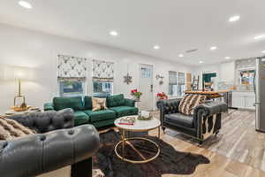 Living room with light hardwood / wood-style floors