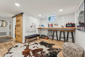 Interior space featuring a barn door and light hardwood / wood-style flooring