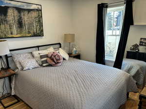 Bedroom with hardwood / wood-style floors