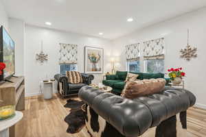 Living room with light hardwood / wood-style floors