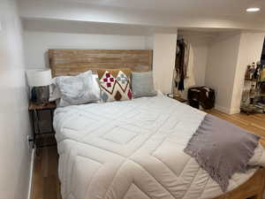 Bedroom with hardwood / wood-style flooring