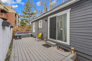 Wooden deck featuring a hot tub