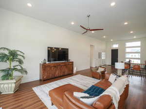 Living room with ceiling fan and hardwood / wood-style floors