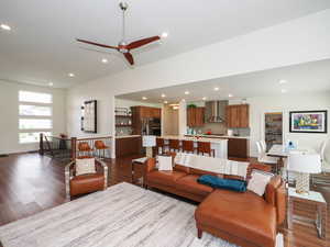 Living room featuring ceiling fan and wood-type flooring