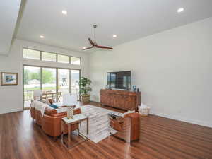 Living room featuring dark hardwood / wood-style floors and ceiling fan