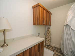 Laundry room featuring cabinets, washer hookup, dark parquet flooring, and hookup for an electric dryer