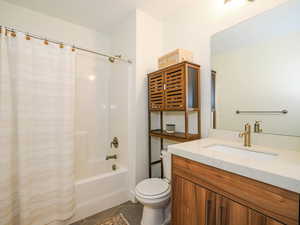 Full bathroom featuring tile patterned flooring, vanity, shower / tub combo, and toilet