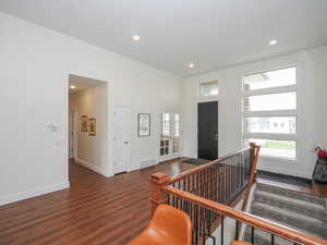 Foyer entrance with dark hardwood / wood-style flooring and french doors