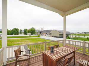 CoveredWooden terrace with a yard