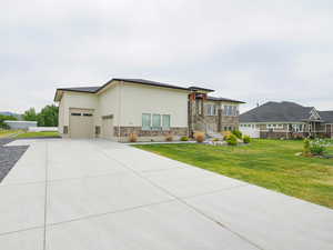 View of front facade with a garage and a front lawn