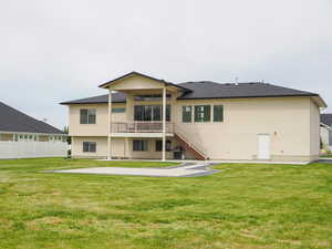 Back of house with a lawn