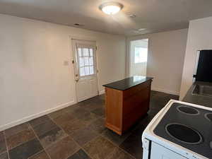 Kitchen featuring a kitchen island and stove