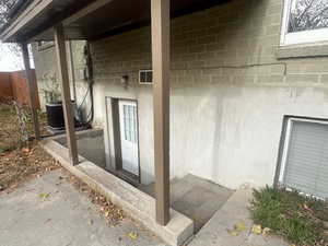 Property entrance featuring cooling unit