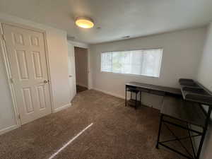 Office featuring dark colored carpet