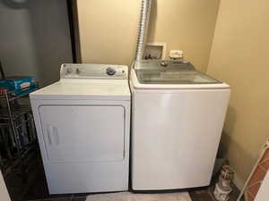 Clothes washing area featuring separate washer and dryer