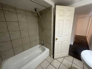 Bathroom with tile patterned flooring and tiled shower / bath