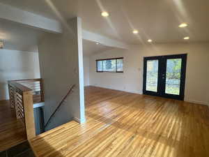 Interior space featuring hardwood / wood-style floors, lofted ceiling with beams, and french doors