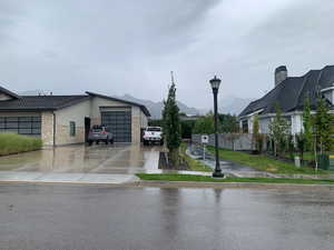 View of side of home featuring a mountain view and a garage