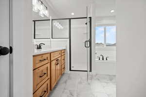 Bathroom featuring vanity and plus walk in shower