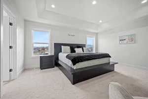 Carpeted bedroom with multiple windows