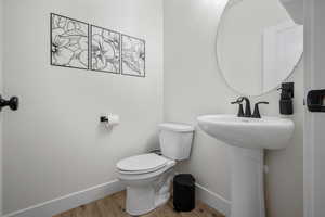 Bathroom featuring hardwood / wood-style floors and toilet