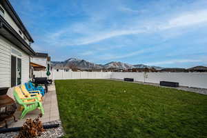 View of yard featuring a mountain view, a patio area, and an outdoor hangout area