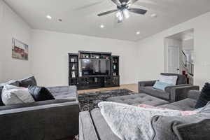 Living room featuring hardwood / wood-style flooring and ceiling fan