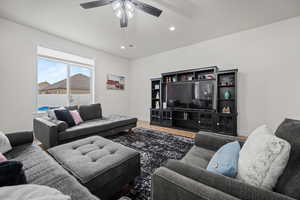 Living room featuring hardwood / wood-style floors and ceiling fan