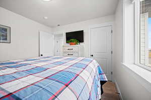 Carpeted bedroom featuring a closet