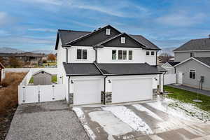 View of front facade featuring a mountain view and a garage