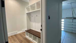 Mudroom with hardwood / wood-style flooring