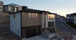 Property exterior at dusk featuring a garage