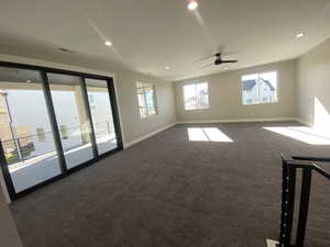 Carpeted empty room featuring ceiling fan