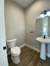 Bathroom with wood-type flooring and toilet