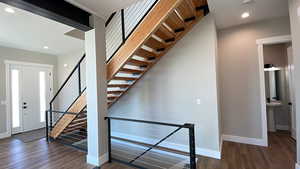 Stairway featuring wood-type flooring