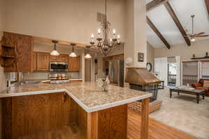 Kitchen featuring kitchen peninsula/breakfast bar, and appliances with stainless steel finishes.