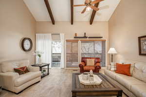 Living room featuring beamed ceiling and balcony