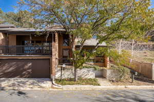 View of front facade featuring a balcony and a garage