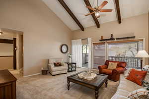 Living room featuring beamed ceiling and balcony