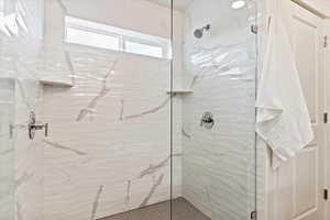 Bathroom featuring tiled shower