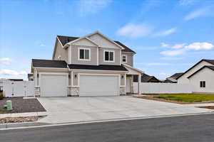 View of front of property featuring a garage and a front yard