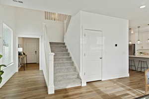 Staircase with hardwood / wood-style floors