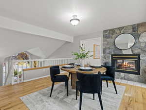 Dining space featuring a fireplace, and hardwood flooring