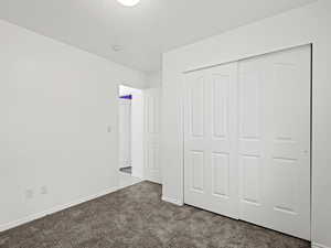 Bedroom #5 with a closet, carpet, and a textured ceiling