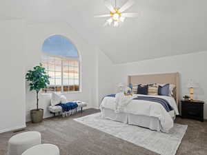 Primary bedroom, featuring ceiling fan and vaulted ceiling