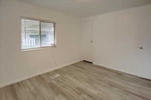 Spare room featuring light hardwood / wood-style floors