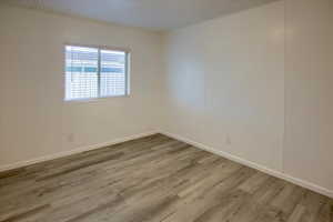 Spare room with light hardwood / wood-style floors